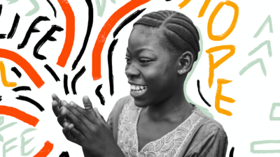 Young African girl smiling and clapping hands in front of 'Words of Life' typographic background.